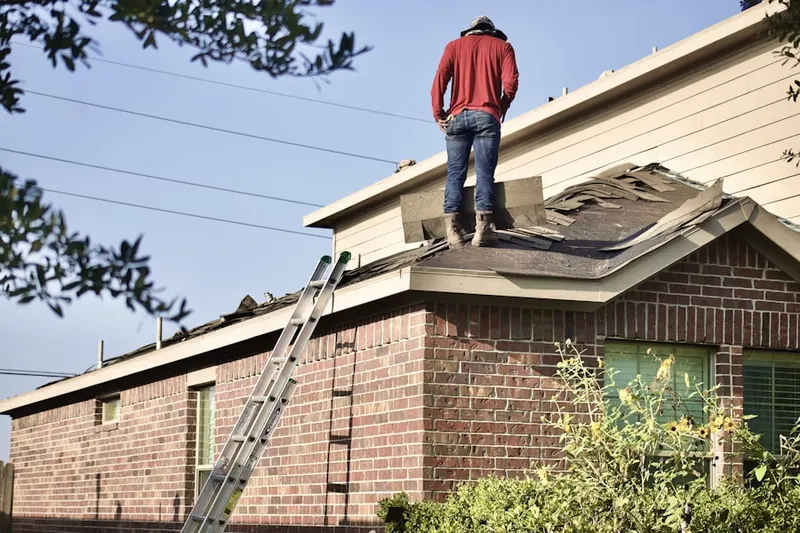 Professional roofer working on a residential roof in Dickerson Corner